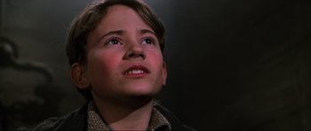Movie still from “Enemy at the Gates” (2001), directed by Jean-Jacques Annaud – A young boy looking up into the sky; Close Up shot, Low angle