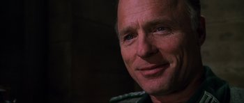 Movie still from “Enemy at the Gates” (2001), directed by Jean-Jacques Annaud – A man's face in a dark room; Close Up shot, Over the shoulder angle