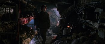 Movie still from “Enemy at the Gates” (2001), directed by Jean-Jacques Annaud – A man walking down a street in a dark place; Wide shot, Low angle