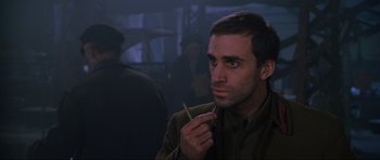 Movie still from “Enemy at the Gates” (2001), directed by Jean-Jacques Annaud – A man holding a cigarette in his mouth; Close Up shot, Over the shoulder angle