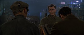 Movie still from “Enemy at the Gates” (2001), directed by Jean-Jacques Annaud – A group of men standing next to each other in a room; Close Up shot, Over the shoulder angle