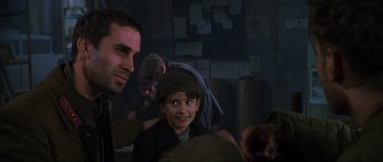 Movie still from “Enemy at the Gates” (2001), directed by Jean-Jacques Annaud – A man and a boy are sitting next to each other in a room; Close Up shot, Over the shoulder angle