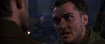 Movie still from “Enemy at the Gates” (2001), directed by Jean-Jacques Annaud – A man's face in a dark room; Close Up shot, Low angle