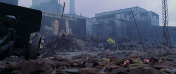 Movie still from “Enemy at the Gates” (2001), directed by Jean-Jacques Annaud – A group of dead bodies laying in the middle of a destroyed city; Extreme Wide shot, High angle