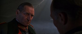Movie still from “Enemy at the Gates” (2001), directed by Jean-Jacques Annaud – An older man in a military uniform looking at a younger man; Close Up shot, Over the shoulder angle