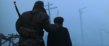 Movie still from “Enemy at the Gates” (2001), directed by Jean-Jacques Annaud – Two men standing next to each other in the fog; Medium shot, Low angle
