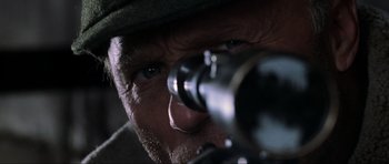 Movie still from “Enemy at the Gates” (2001), directed by Jean-Jacques Annaud – A man looking through a rifle scope; Extreme Close Up shot, Low angle
