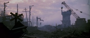 Movie still from “Enemy at the Gates” (2001), directed by Jean-Jacques Annaud – A man standing on top of a pile of rubble; Extreme Wide shot, Low angle