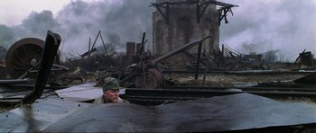 Movie still from “Enemy at the Gates” (2001), directed by Jean-Jacques Annaud – A man is looking out of the window of an abandoned train; Wide shot, High angle