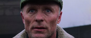 Movie still from “Enemy at the Gates” (2001), directed by Jean-Jacques Annaud – A person wearing a hat; Close Up shot, Low angle