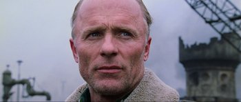 Movie still from “Enemy at the Gates” (2001), directed by Jean-Jacques Annaud – A person wearing a jacket; Close Up shot, Low angle