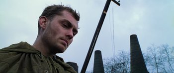 Movie still from “Enemy at the Gates” (2001), directed by Jean-Jacques Annaud – A person holding a stick; Close Up shot, Low angle