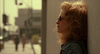 Movie still from “Erin Brockovich” (2000), directed by Steven Soderbergh – A person wearing a jean jacket and sunglasses; Close Up shot, Over the shoulder angle