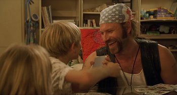 Movie still from “Erin Brockovich” (2000), directed by Steven Soderbergh – A man and a boy are laughing together; Close Up shot, Over the shoulder angle