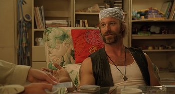 Movie still from “Erin Brockovich” (2000), directed by Steven Soderbergh – A man sitting at a table in a living room; Medium shot, Over the shoulder angle