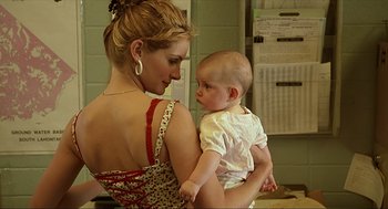 Movie still from “Erin Brockovich” (2000), directed by Steven Soderbergh – A woman holding a baby in her arms; Close Up shot, Over the shoulder angle