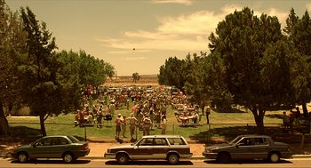 Movie still from “Erin Brockovich” (2000), directed by Steven Soderbergh – A crowd of people gathered in a field; Extreme Wide shot, High angle