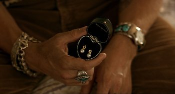 Movie still from “Erin Brockovich” (2000), directed by Steven Soderbergh – A person holding a pair of earrings in a case; Extreme Close Up shot, High angle
