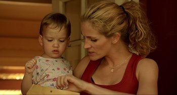 Movie still from “Erin Brockovich” (2000), directed by Steven Soderbergh – A woman and a child are looking at a piece of paper; Close Up shot, Low angle