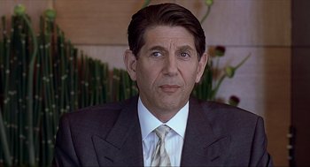 Movie still from “Erin Brockovich” (2000), directed by Steven Soderbergh – A person wearing a suit and tie; Close Up shot, Over the shoulder angle