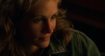 Movie still from “Erin Brockovich” (2000), directed by Steven Soderbergh – A woman's face in the dark; Close Up shot, Over the shoulder angle