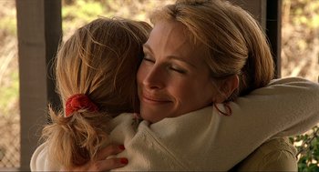 Movie still from “Erin Brockovich” (2000), directed by Steven Soderbergh – A person hugging another person; Close Up shot, Over the shoulder angle