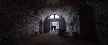 Movie still from “A Hidden Life” (2019), directed by Terrence Malick – Three people are standing in an old building; Extreme Wide shot, Low angle
