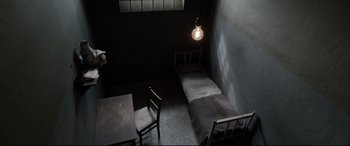 Movie still from “A Hidden Life” (2019), directed by Terrence Malick – A room with a bed , table and a lamp; Extreme Wide shot, High angle