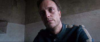 Movie still from “A Hidden Life” (2019), directed by Terrence Malick – A person looking at the camera; Close Up shot, Low angle