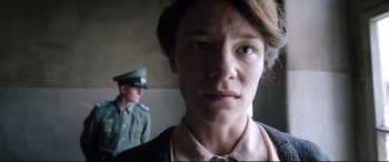 Movie still from “A Hidden Life” (2019), directed by Terrence Malick – A woman in a uniform and a man in a military uniform; Close Up shot, Low angle