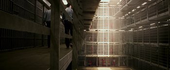 Movie still from “Escape Plan” (2013), directed by Mikael Håfström – A group of people standing inside of a jail cell; Extreme Wide shot, High angle