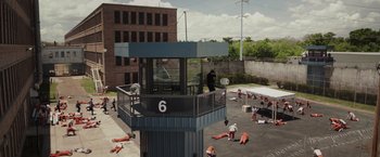 Movie still from “Escape Plan” (2013), directed by Mikael Håfström – A group of people laying on the ground in a jail cell; Extreme Wide shot, High angle
