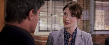 Movie still from “Escape Plan” (2013), directed by Mikael Håfström – A woman in a gray jacket and a man in a black and white tie; Close Up shot, Over the shoulder angle