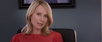 Movie still from “Escape Plan” (2013), directed by Mikael Håfström – A woman sitting in a chair wearing a red shirt; Close Up shot, Over the shoulder angle