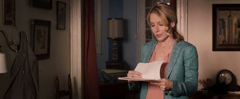 Movie still from “Escape Plan” (2013), directed by Mikael Håfström – A woman is reading a book in a room; Medium shot, Over the shoulder angle