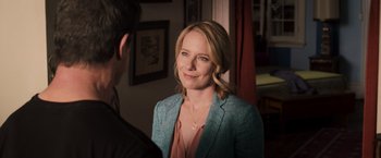 Movie still from “Escape Plan” (2013), directed by Mikael Håfström – A woman wearing a blue jacket standing next to a man; Close Up shot, Over the shoulder angle