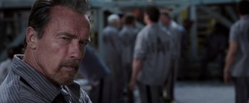 Movie still from “Escape Plan” (2013), directed by Mikael Håfström – A group of people in a room next to each other; Close Up shot, Over the shoulder angle