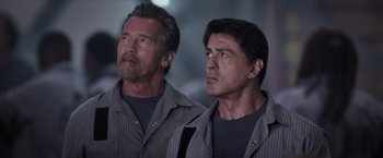 Movie still from “Escape Plan” (2013), directed by Mikael Håfström – A couple of men standing next to each other; Close Up shot, Low angle
