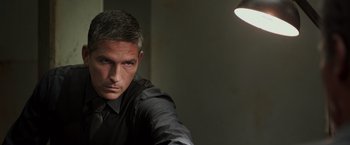 Movie still from “Escape Plan” (2013), directed by Mikael Håfström – A person wearing a black shirt; Close Up shot, High angle