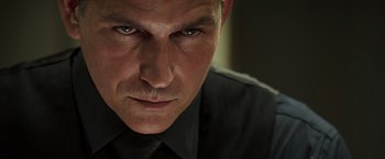 Movie still from “Escape Plan” (2013), directed by Mikael Håfström – A person wearing a shirt and tie; Close Up shot, Low angle