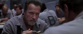 Movie still from “Escape Plan” (2013), directed by Mikael Håfström – An older man holding a wooden spoon in his hand; Close Up shot, Over the shoulder angle