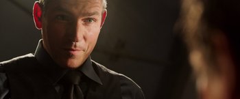 Movie still from “Escape Plan” (2013), directed by Mikael Håfström – A person wearing a shirt and tie; Close Up shot, Low angle