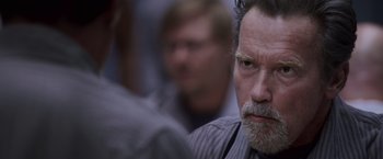 Movie still from “Escape Plan” (2013), directed by Mikael Håfström – A person with a beard; Close Up shot, Over the shoulder angle