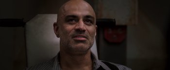 Movie still from “Escape Plan” (2013), directed by Mikael Håfström – A man with a bald head looking into the camera; Close Up shot, Low angle