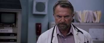Movie still from “Escape Plan” (2013), directed by Mikael Håfström – A man with a stethoscope around his neck; Close Up shot, Low angle