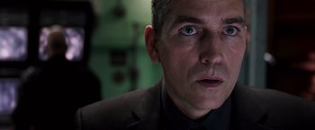 Movie still from “Escape Plan” (2013), directed by Mikael Håfström – A person wearing a suit and tie; Close Up shot, Low angle