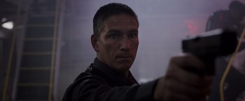 Movie still from “Escape Plan” (2013), directed by Mikael Håfström – A person holding a gun in his hand; Close Up shot, Low angle