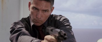 Movie still from “Escape Plan” (2013), directed by Mikael Håfström – A person holding a gun; Close Up shot, Over the shoulder angle