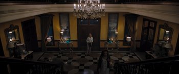 Movie still from “Escape Room: Tournament of Champions” (2021), directed by Adam Robitel – A woman standing in front of a door in a room; Extreme Wide shot, High angle