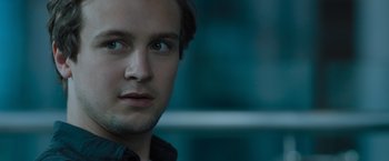 Movie still from “Escape Room: Tournament of Champions” (2021), directed by Adam Robitel – A man's face in front of a building; Close Up shot, Over the shoulder angle